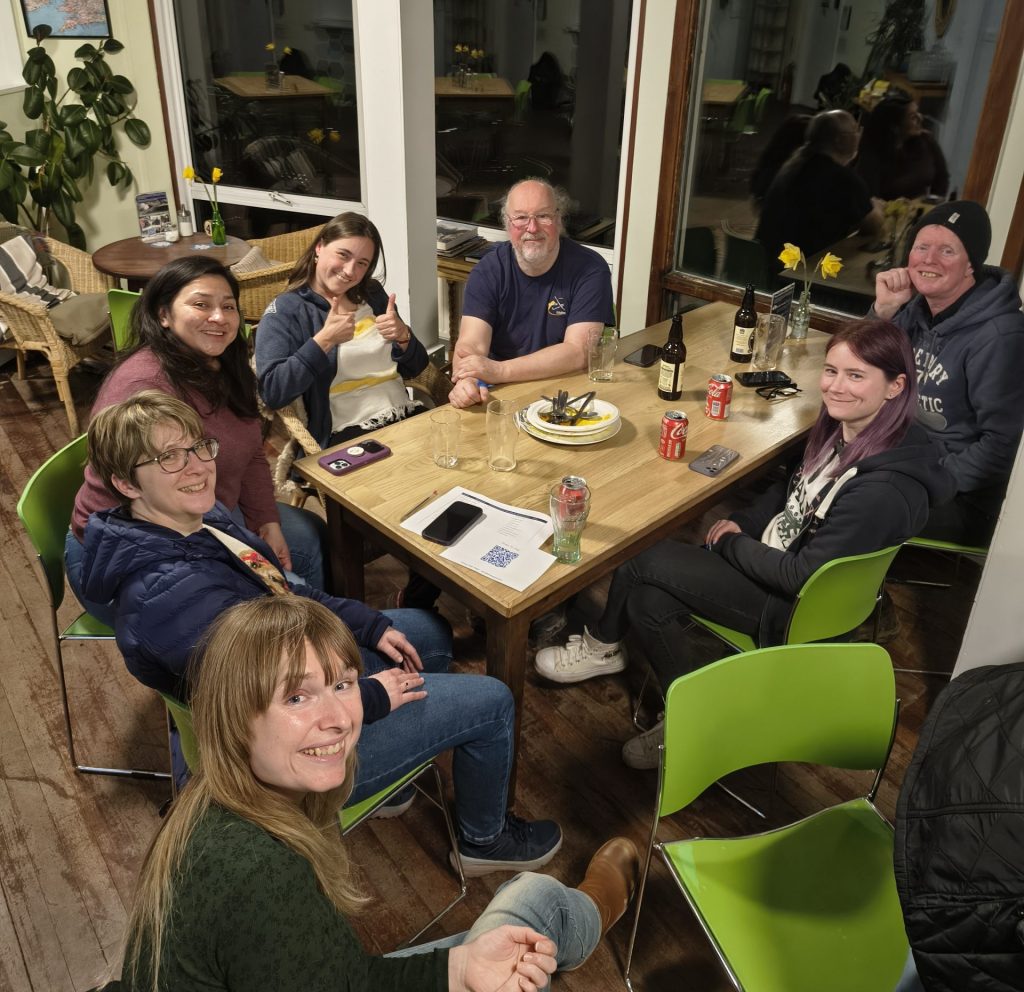 Photo of a group of Women Gliding folks enjoying a chat and a drink in the bar