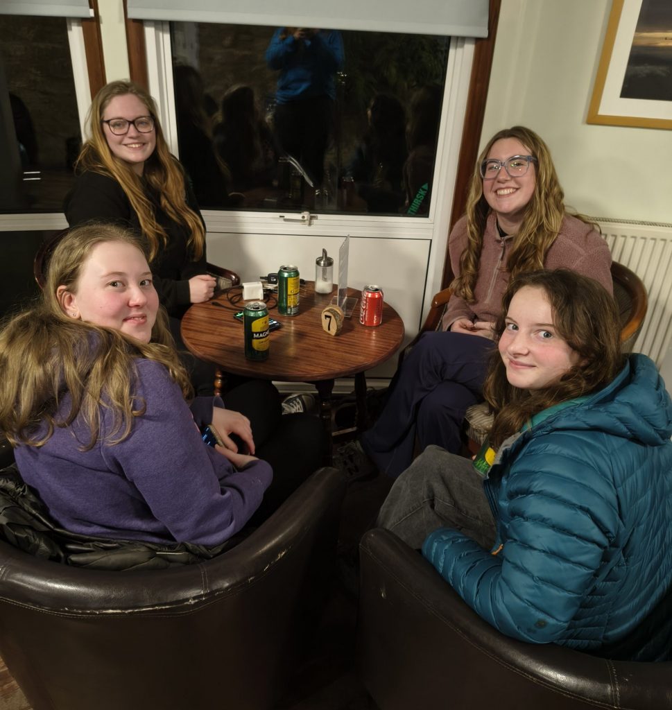 Photo of a group of Women Gliding visitors enjoying a chat and a drink in the bar