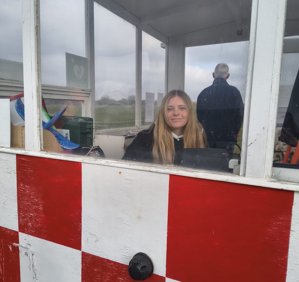 photo of a female launch point controller sitting in the launch point vehicle, keeping an eye on the operations.
